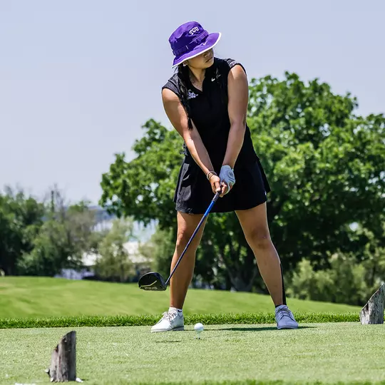Kirstin Angosta gazes down the fairway as she prepares to hit a tee shot.