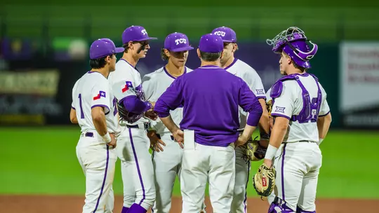 The team huddles on the mound.