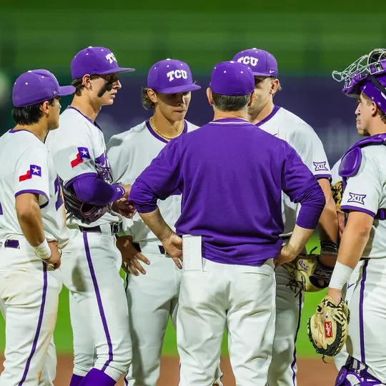 The team huddles on the mound.