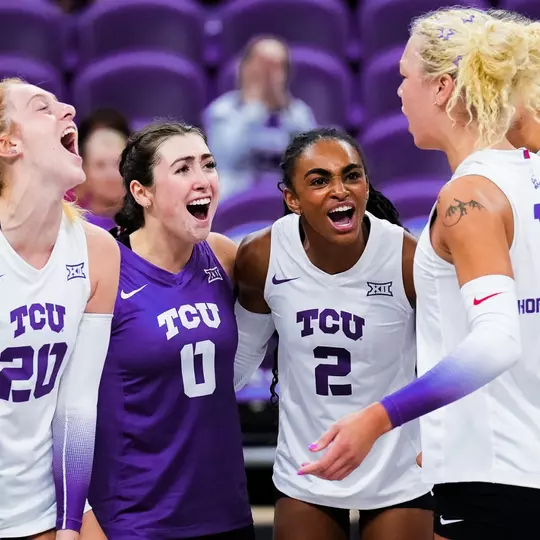 TCU Volleyball players celebrate scoring a point together