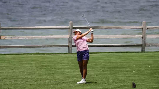 Kirstin Angosta follows through and tracks her ball following a tee shot.