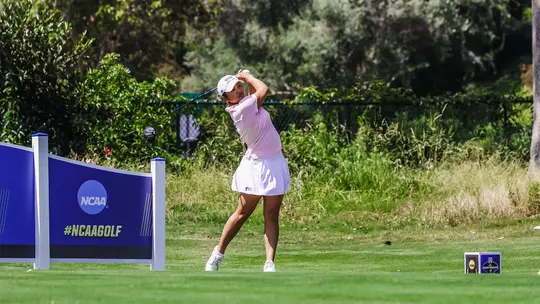 Kirstin Angosta follows her ball after a tee shot.