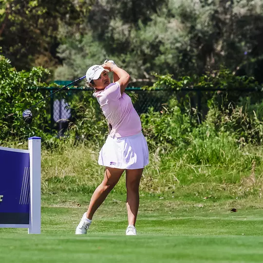 Kirstin Angosta follows her ball after a tee shot.