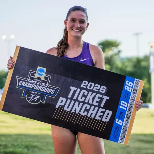 Georgia Scott holding a ticket punched sign for the NCAA Championships