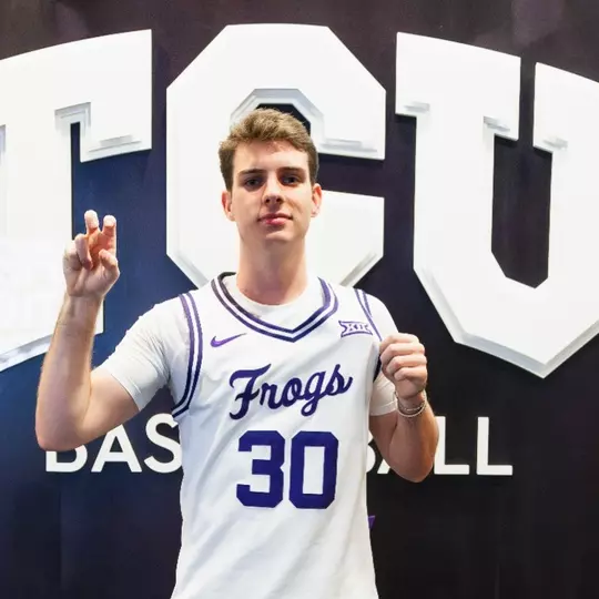 Gavin Murphy, wearing a white jersey, poses for the camera.