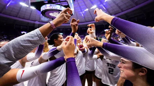 TCU Volleyball players in a huddle