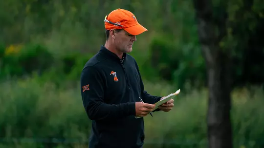 Greg Robertson looks over a golf pin sheet during a tournament.