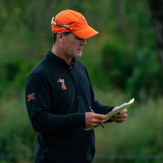 Greg Robertson looks over a golf pin sheet during a tournament.