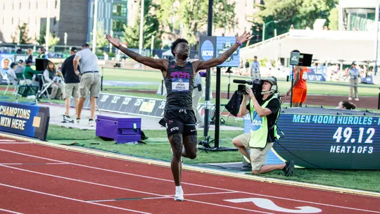 TCU track and field's Jayden Douglas run across the finish line and celebrates after breaking the school record in the 400m hurdles
