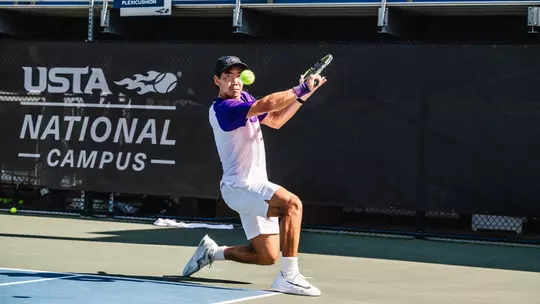 Duncan Chan makes eye contact with a tennis ball as he prepares to hit a slice