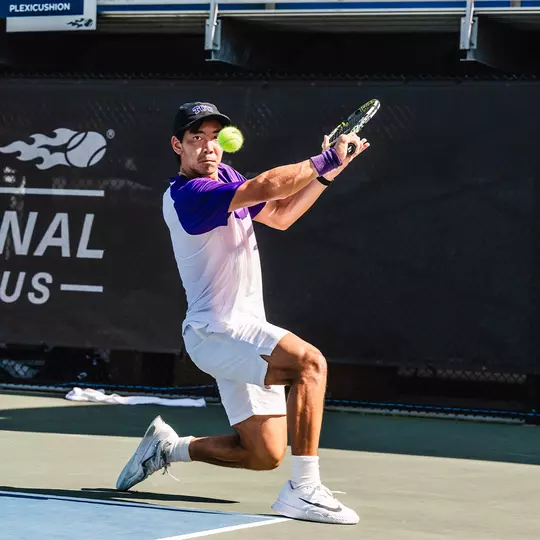 Duncan Chan makes eye contact with a tennis ball as he prepares to hit a slice