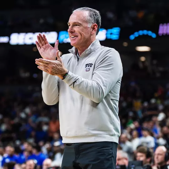 Jamie Dixon claps his hands.