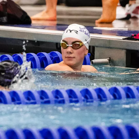 Sydney Inman looks at the scoreboard after finishing the race