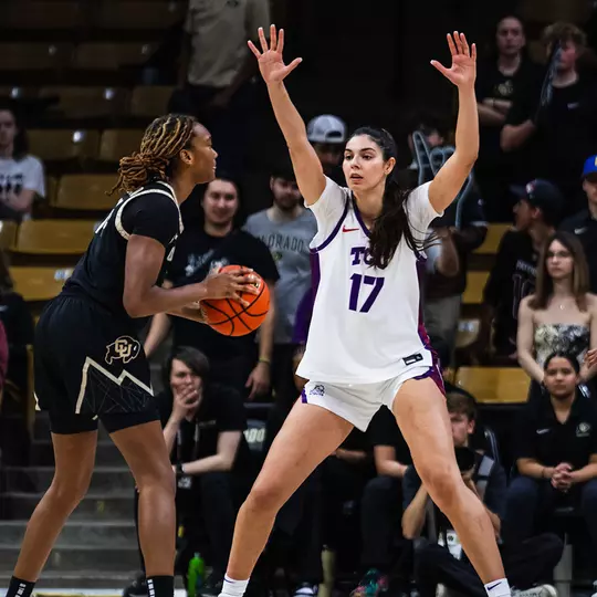 Clara Silva raises her arms outside the paint to defend a passing lane.