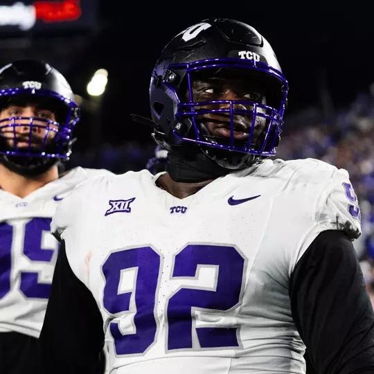 Ansel Din-Mbuh in a white jersey and black helmet