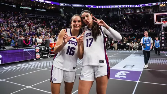 Clara Bielefeld and Clara Silva celebrate following a win in the Big 12 Tournament