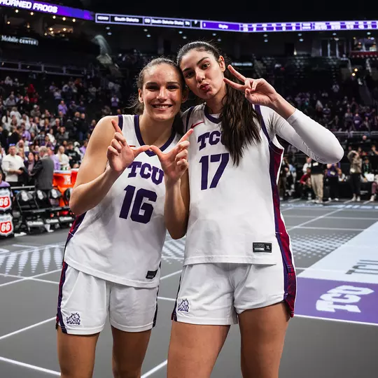 Clara Bielefeld and Clara Silva celebrate following a win in the Big 12 Tournament