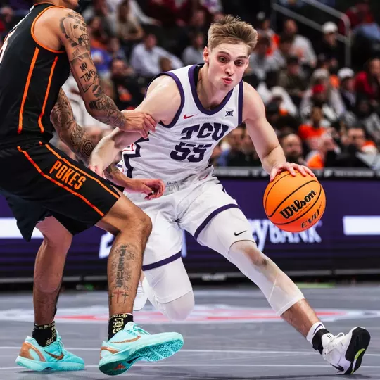 Tanner Toolson drives the ball against Oklahoma State