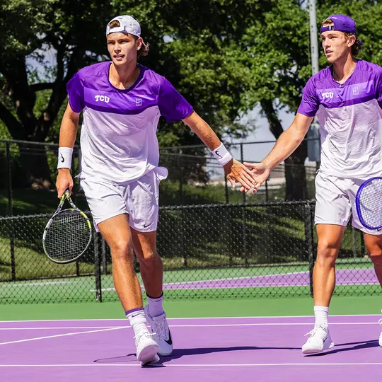 Albert Pedrico and Cooper Woestendick celebrate a point in a doubles match.