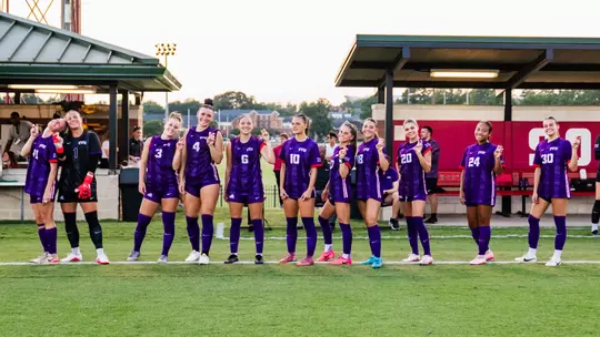 TCU women's soccer starting XI against Alabama smiling at camera