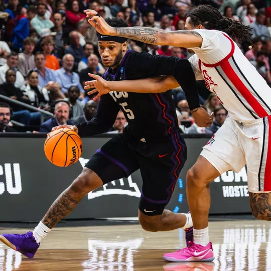 Micah Robinson gets by an Ohio State defender while Jamie Dixon looks on