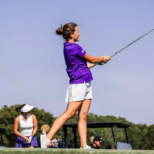 Ella Forss follows through on a tee shot and tracks her ball path
