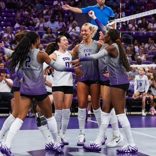 TCU Volleyball huddles together and celebrates a point