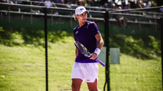 Cooper Woestendick reacts to winning a point wearing a purple shirt