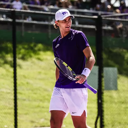 Cooper Woestendick reacts to winning a point wearing a purple shirt