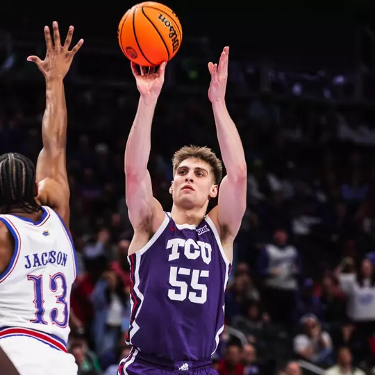 Tanner Toolson shoots the ball over Kansas defender at the Big 12 Tournament