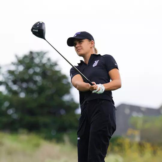 Camille Min-Gaultier follows through on a tee shot and tracks her ball