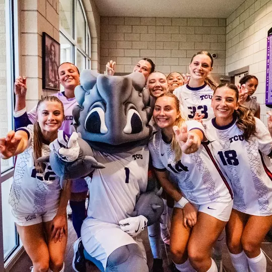 TCU women's soccer team with Super Frog