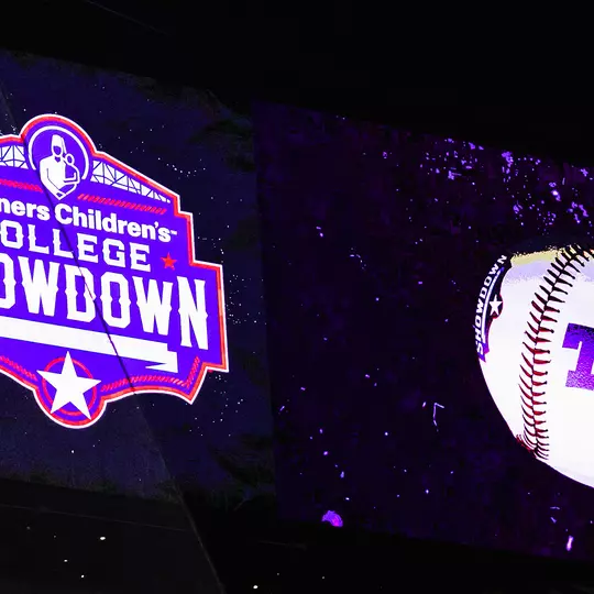 Globe Life Field Scoreboard featuring Shriner's logo and baseball with TCU logo.