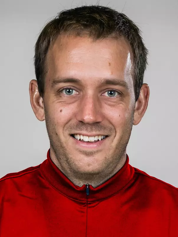 Ben Mallue headshot with red jacket