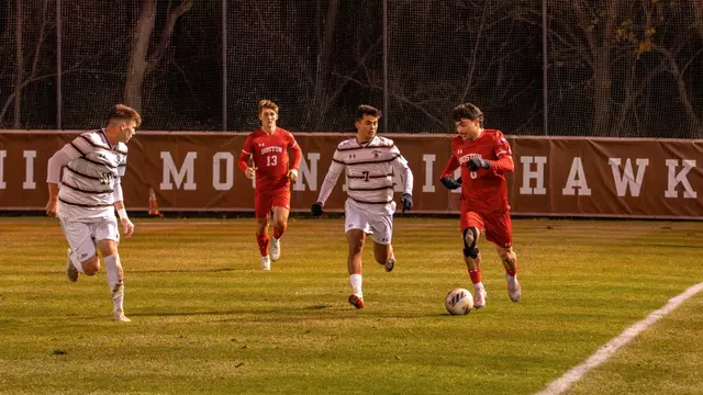 Boston University men's soccer dribbles the ball up the field with Lehigh defender on the side