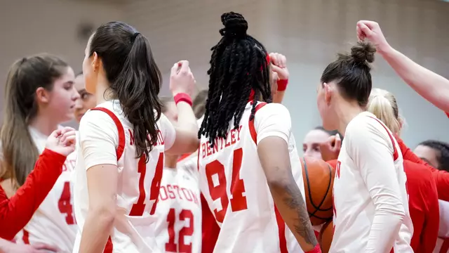 Photo of the BU Women's Basketball team huddling at Case Gym.