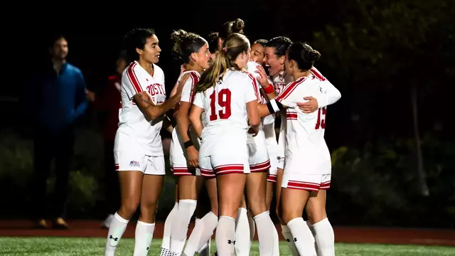 Photo of the BU Women's Soccer team celebrating a goal at Nickerson Field.