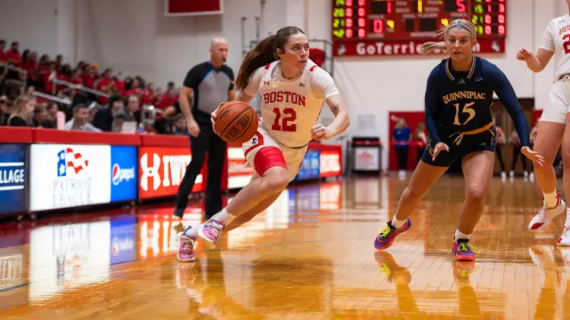 Photo of women's basketball junior Bella McLaughlin dribbling the ball at Case Gym.