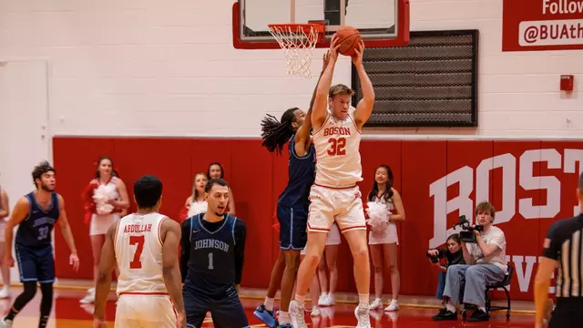 Quinn Nielsen hauls in a pass near the basket.