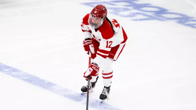 Avery Supryka skating with the puck