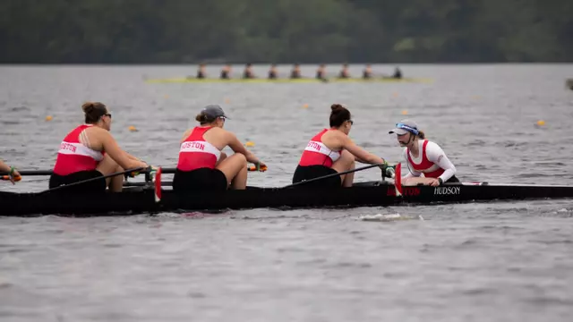 Varsity eight boat races down the lake on the first day of the NCAA Championships