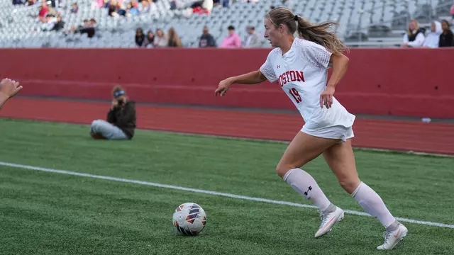 Photo of BU women's soccer senior Ava Maguire dribbling the ball at Nickerson Field.