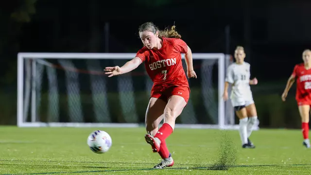 Photo of BU women's soccer sophomore Georgia Prouty shooting a ball at Nickerson Field.