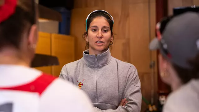 Photo of BU women's rowing assistant coach Anneta Kyridou speaking with the team.