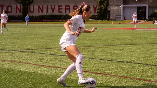 Photo of BU women's soccer junior Olivia Avellar dribbling the ball at Nickerson Field.