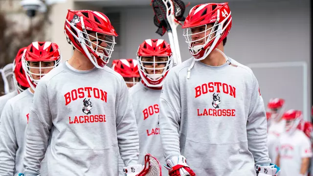 Connor Kehm and Jimmy Kohr walk out to Nickerson Field before a game