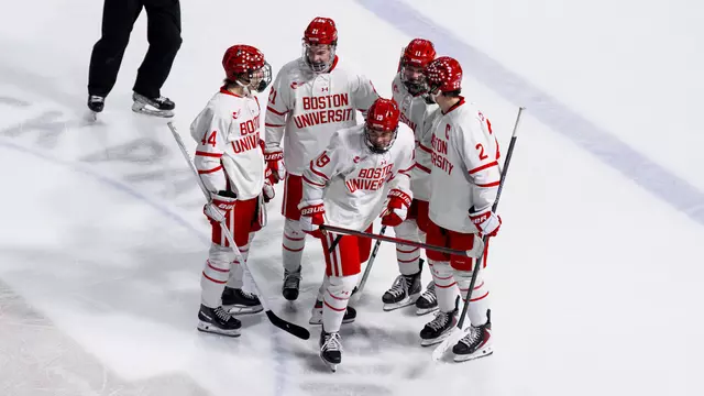 Men's hockey players celebrate a goal against UNH