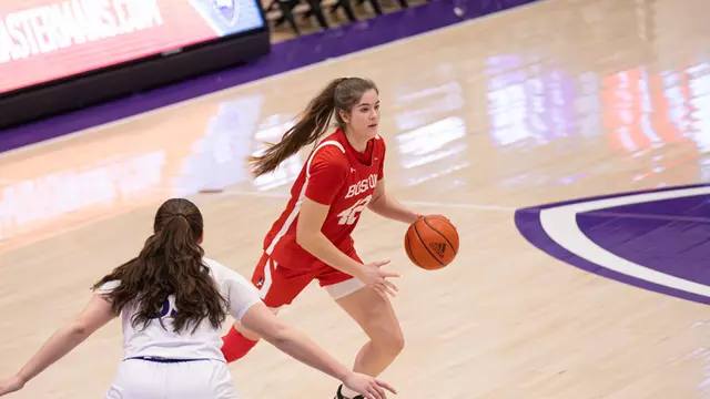 Photo of BU women's basketball sophomore Allison Schwertner dribbling the ball at Holy Cross.