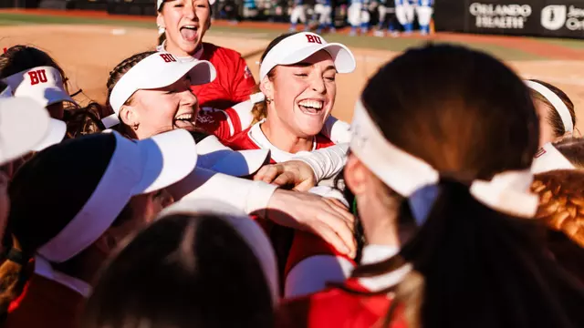 BU softball team celebrates together in a big group hug after upsetting No. 16 Duke