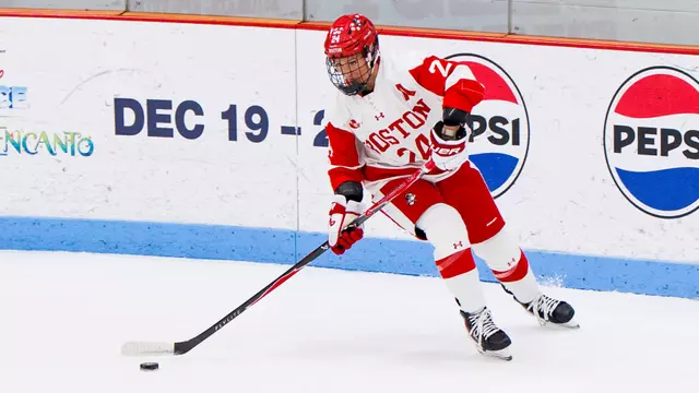 Maeve Kelly skating with the puck at Walter Brown Arena